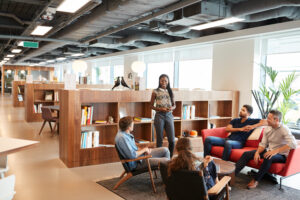 Casually Dressed Businessmen And Businesswomen Having Informal Meeting In Modern Office